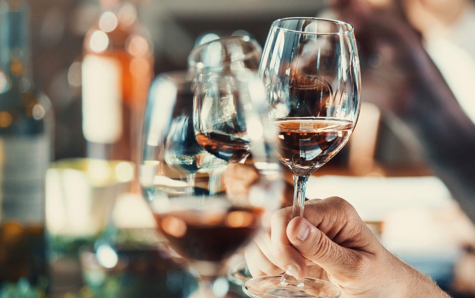 A person holding wine glasses