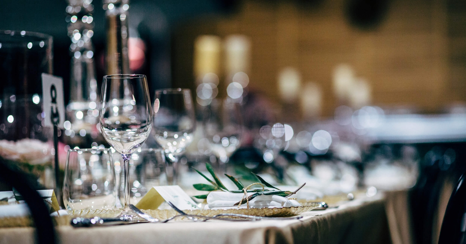 A table with wine glasses and silverware