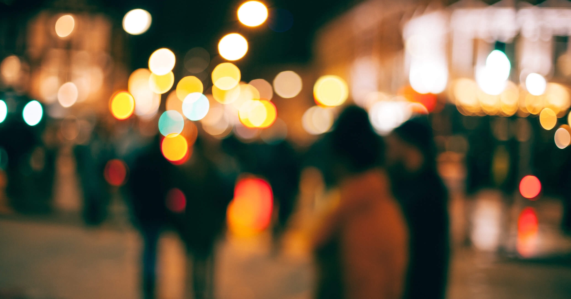 A blurry image of people walking on a street