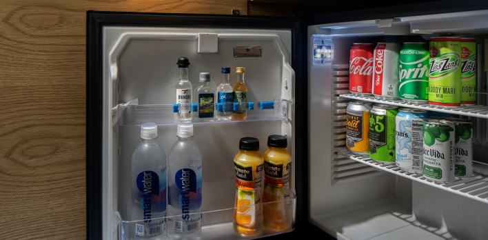 A mini fridge with drinks inside