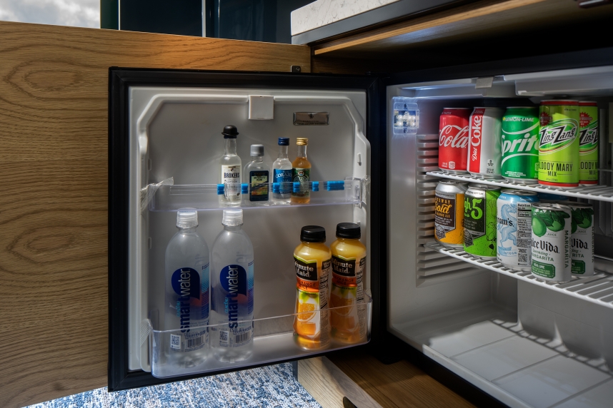 A mini fridge with drinks inside