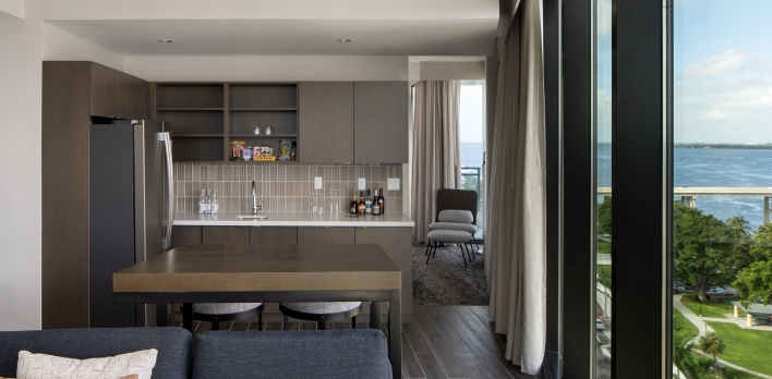 A living room with a kitchen and dining area