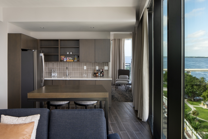 A living room with a kitchen and dining area