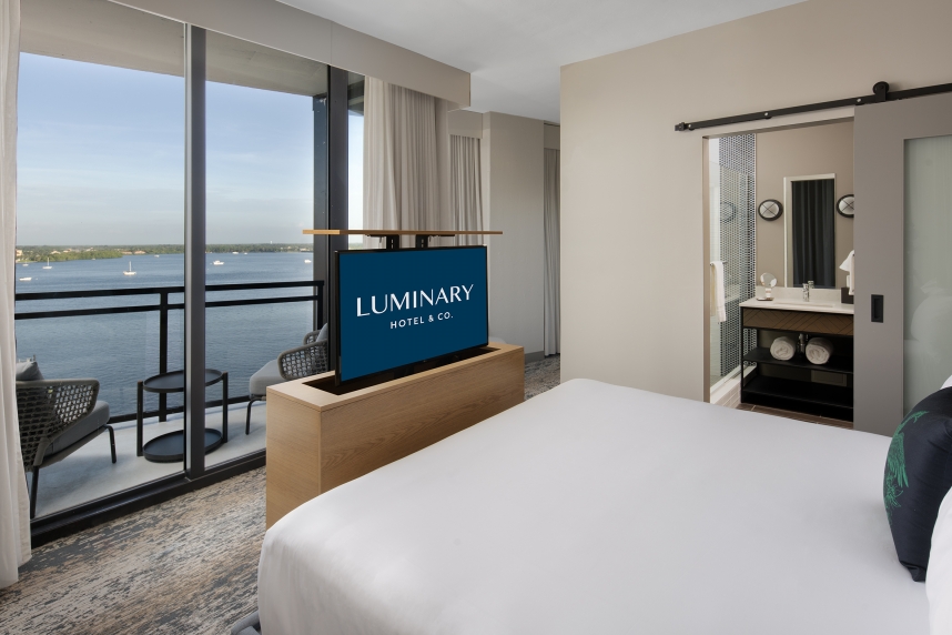 A room with a television and a view of the water