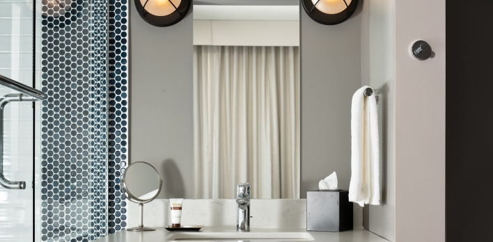 A bathroom with a mirror and a sink