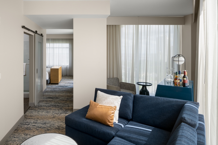 A living room with a blue couch and a blue chair