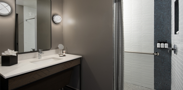 A bathroom with a shower and sink