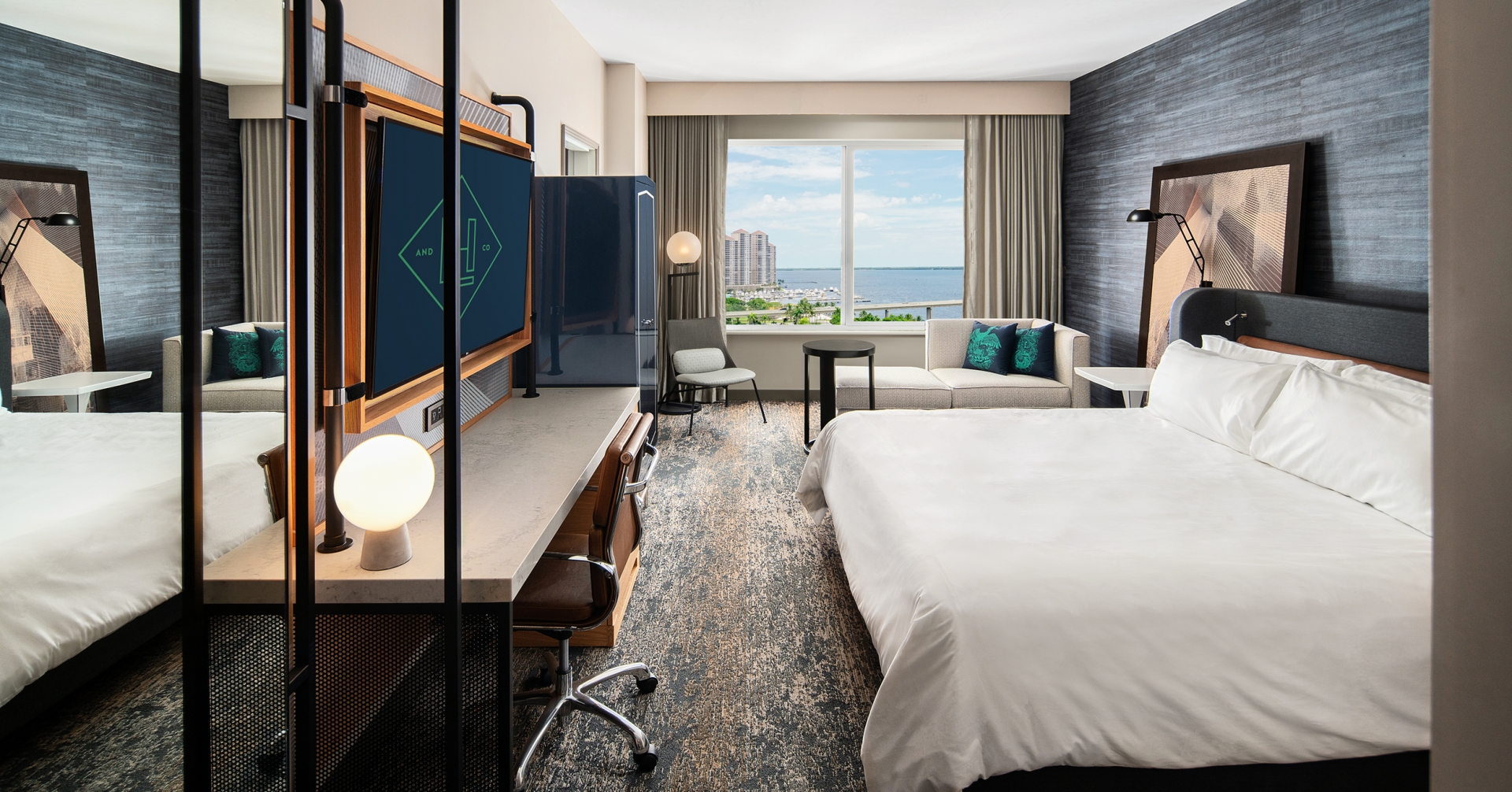 A room with a large bed and a television