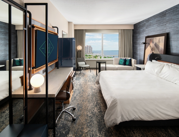 A room with a large bed and a television