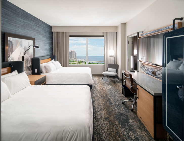 A room with two beds and a window