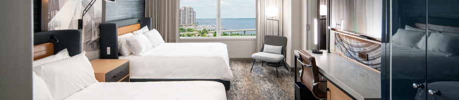 A room with two beds and a window