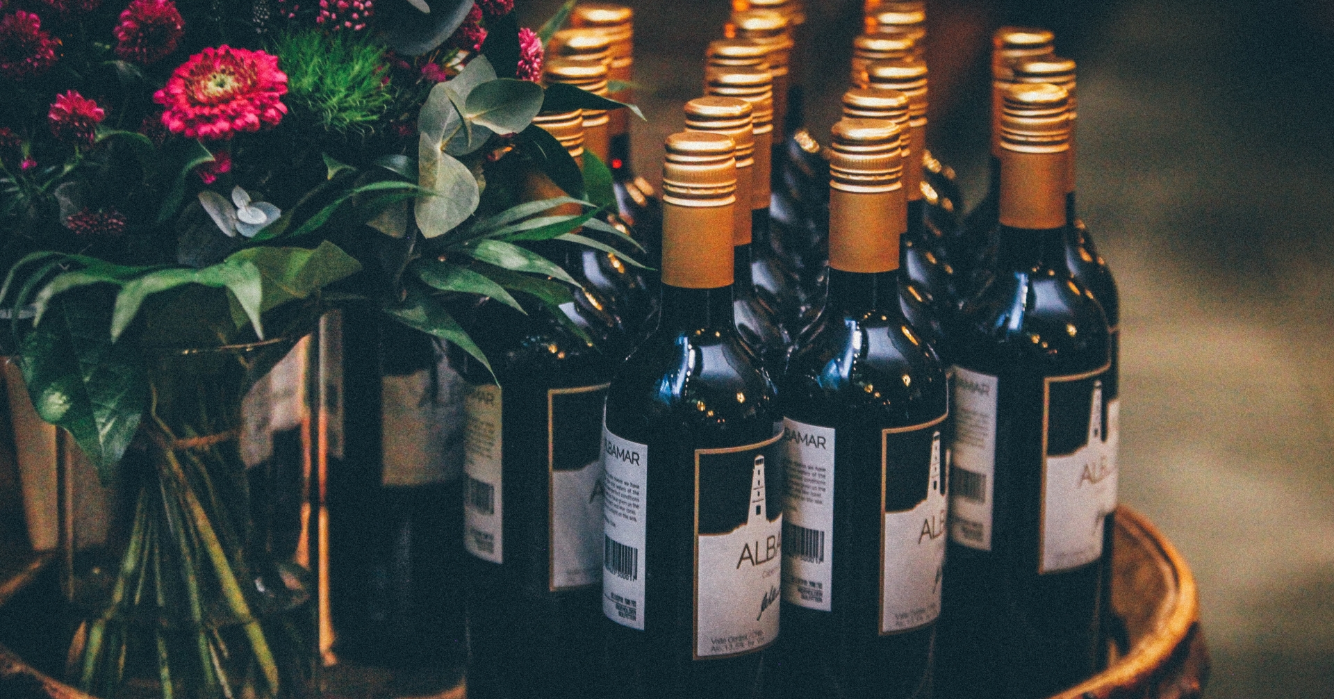 A group of wine bottles and flowers