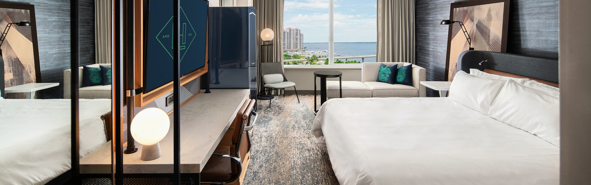 A room with a large bed and a television