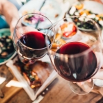 A group of people holding wine glasses