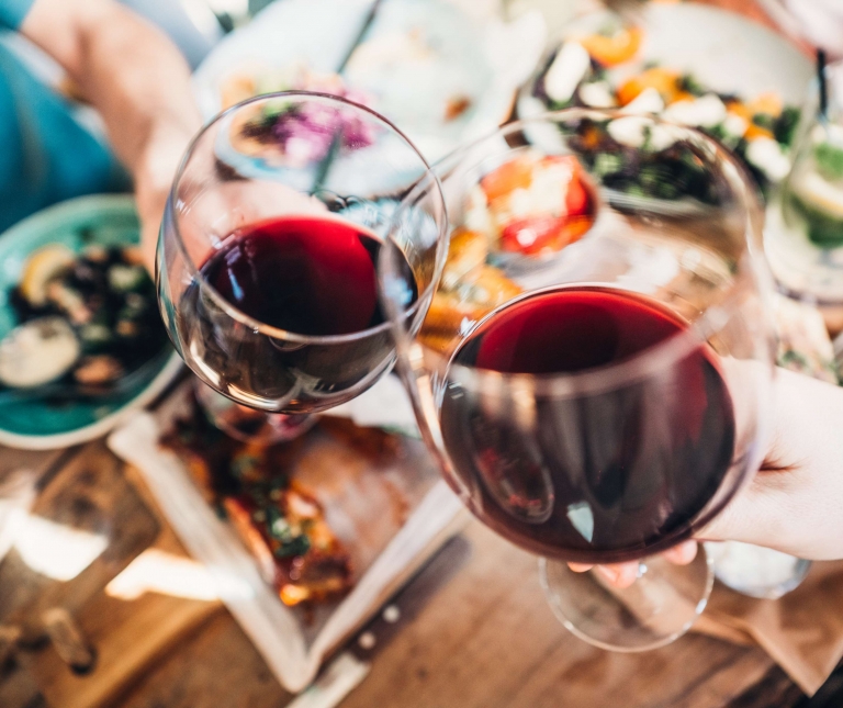 A group of people holding wine glasses
