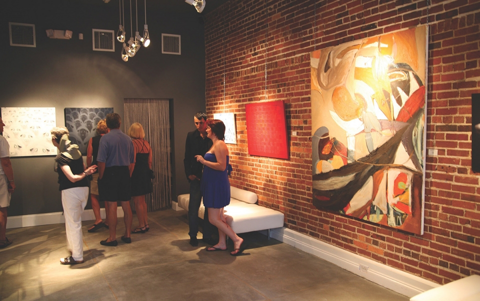 A group of people in a room with art