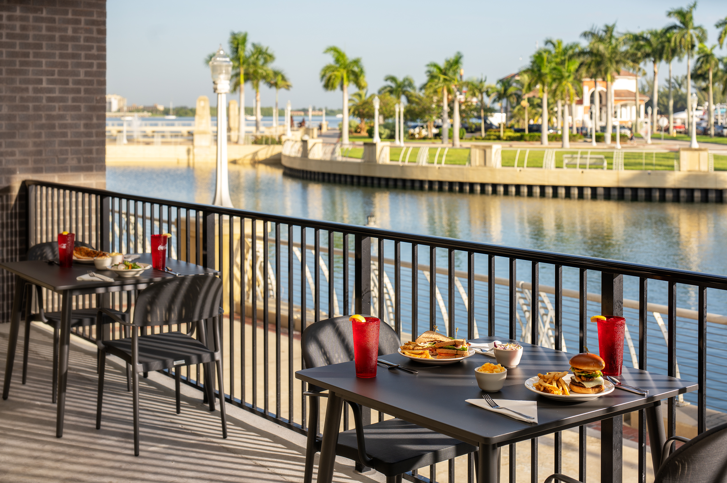 A table and chairs on a deck overlooking a body of water