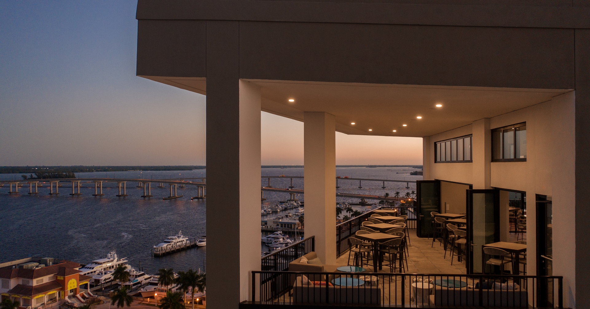 A building with a view of the water and a bridge