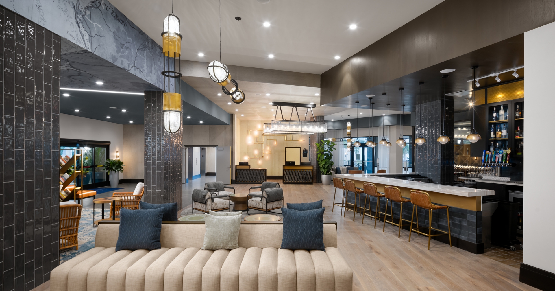 A large room with a long couch and chairs in Luminary hotel & Co.